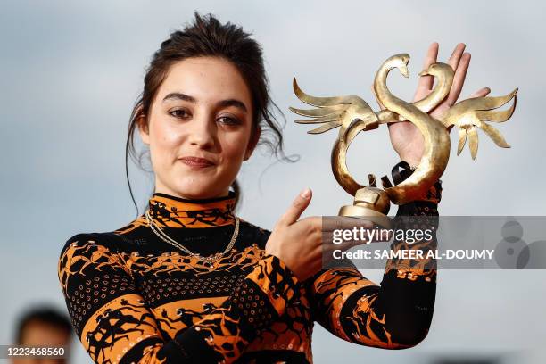 French actress Luana Bajrami poses with the Best Newcomer Prize for "Portrait de la jeune fille en feu during the 34th Cabourg Film Festival on June...