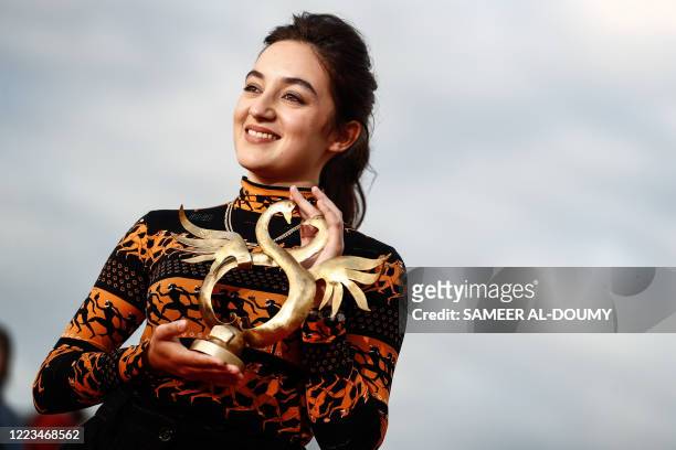 French actress Luana Bajrami poses with the Best Newcomer Prize for "Portrait de la jeune fille en feu during the 34th Cabourg Film Festival on June...