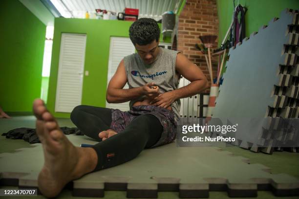 Antonio Palagano, 29 years old, Brazilian jiu-jitsu athlete, photographed applying insulin during physical training at his residence in the Vila...