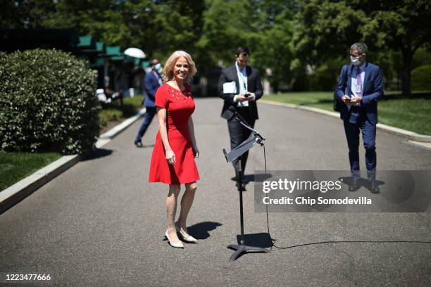 White House Counselor to the President Kellyanne Conway prepare to talk to reporters after three television interviews outside the White House May...