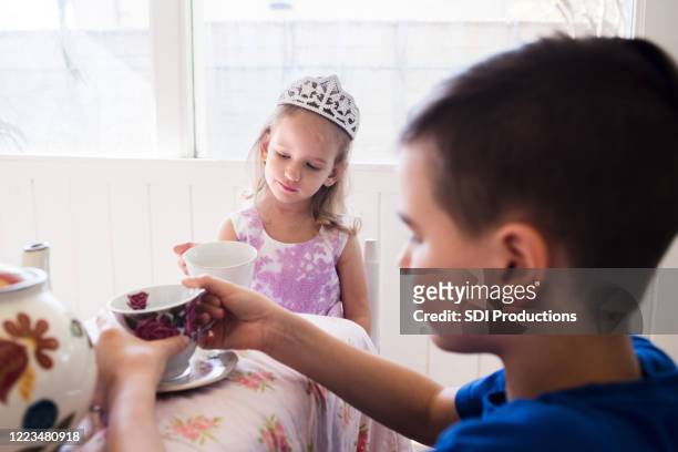 brother and sister play teatime together - boy tiara stock pictures, royalty-free photos & images