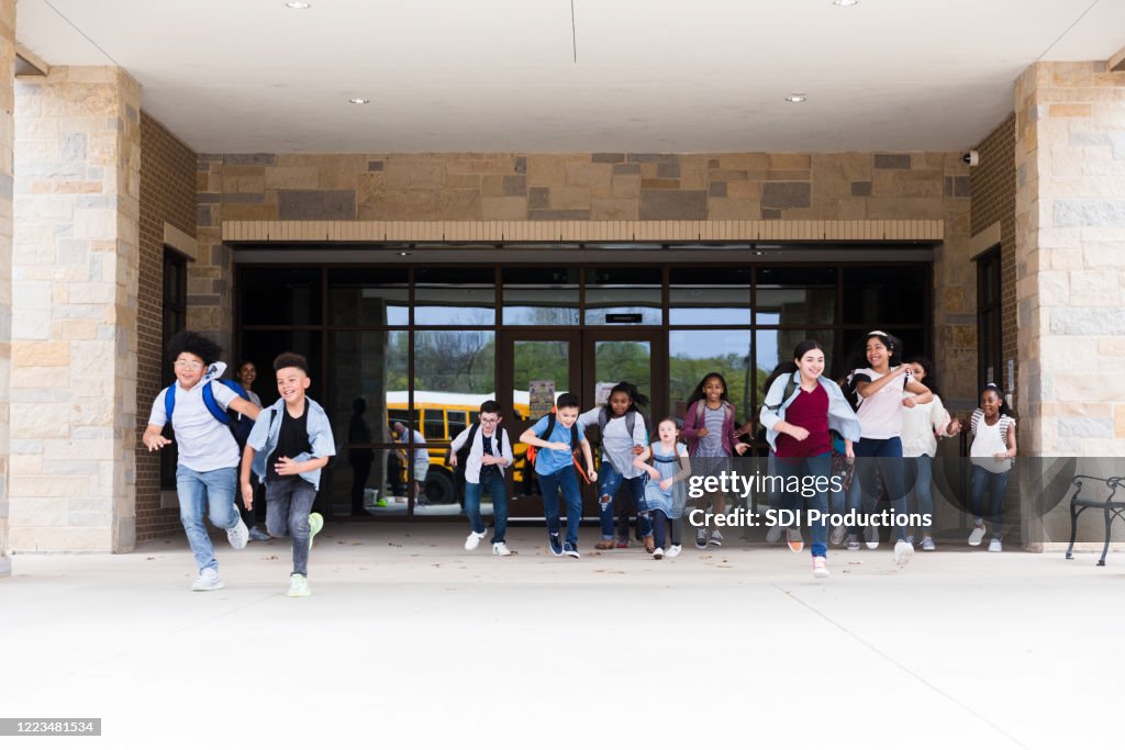 Excited schoolchildren leave school building
