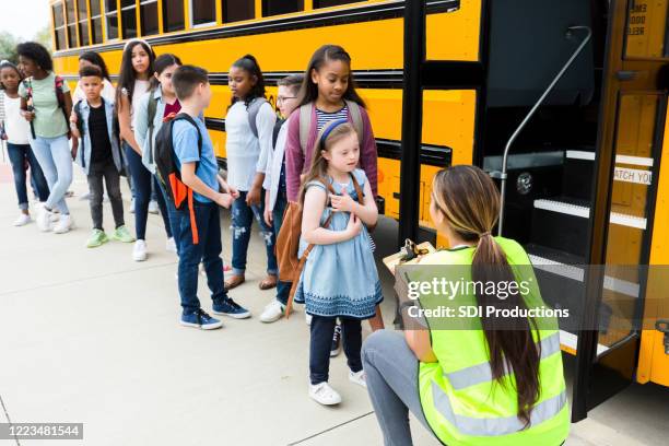 bus driver talks with elementary student - kids lining up stock pictures, royalty-free photos & images
