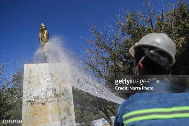 The statue of Juan Escutia, considered a hero, is sprayed with sanitizing liquid that prevents the spread of Covid in the Niños Héroes public square...