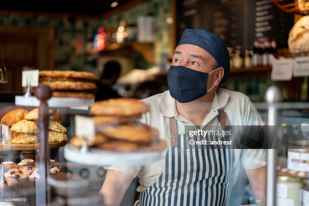 Man working at a coffee shop wearing a facemask