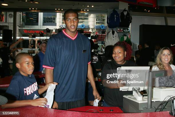 Derrick Favors and brother Brandon visit Champs Sports on June 24, 2010 in New York City.