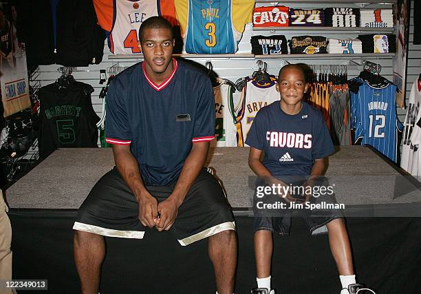 Derrick Favors and brother Brandon visit Champs Sports on June 24, 2010 in New York City.