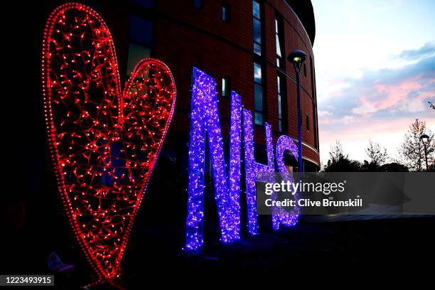 An illuminated sign showing a heart and the letters NHS after the applause for key workers at Salford Royal Hospital on May 07, 2020 in Salford,...