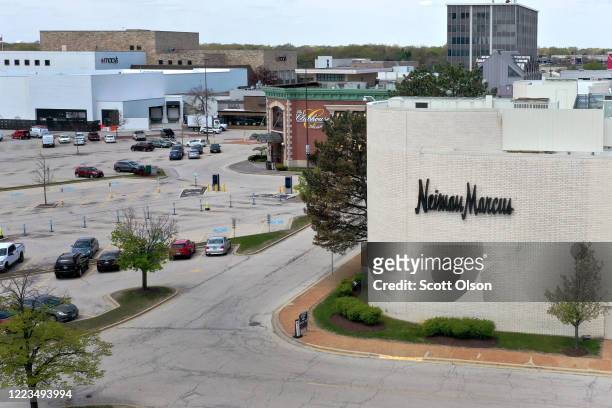 An aerial view from a drone shows the parking lot is nearly empty outside of a Neiman Marcus store that has been shuttered by the COVID-19 pandemic...