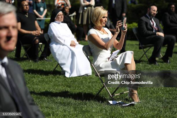 Pastor Paula White, leader of the White House's Faith and Opportunity Initiative, takes photographs while practicing social distancing due to the...