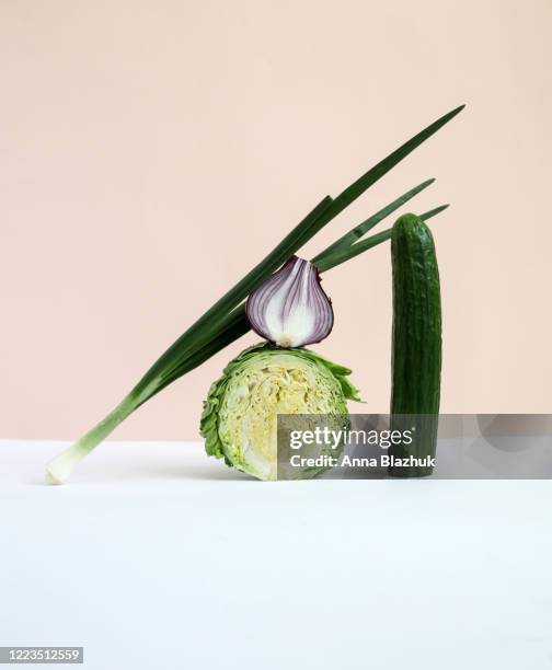 vegetables trendy still life photography: cabbage, onion, cucumber over paper background - raw food stock pictures, royalty-free photos & images