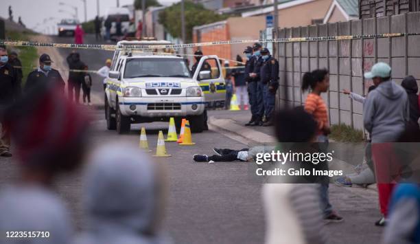 Dead body lies on the ground after a suspected gang related shooting in Lavender Hill on June 29, 2020 in Cape Town, South Africa. It is believed...