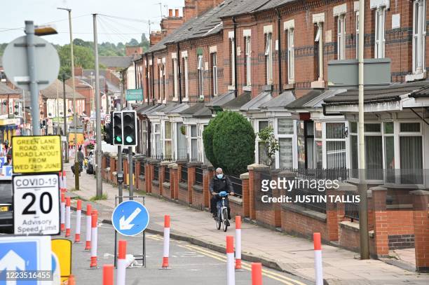 Cones enforce a new road layout turning Green Lane into a one-way street to allow for widened pavements as a measure to limit the spread of COVID-19...