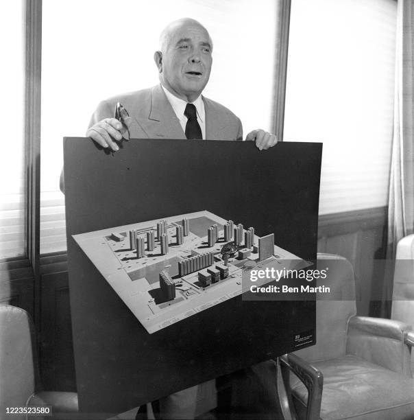 Spyros Skouras , President of 20th Century Fox film studios, with model of the studio lot, 1957.