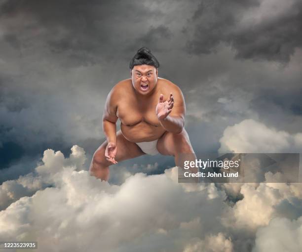 sumo wrestling menace in the cloud - combat sport stock pictures, royalty-free photos & images