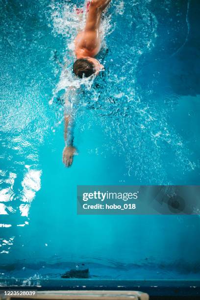 mature adult man swimming - triathlon swim stock pictures, royalty-free photos & images