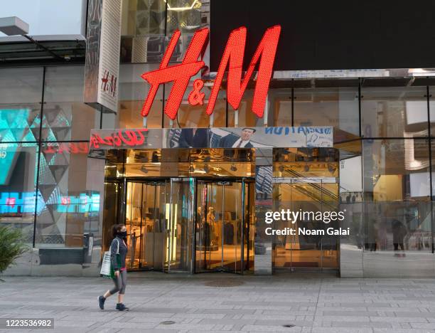 Person wears a protective face mask outside of H&M in Times Square during the coronavirus pandemic on May 7, 2020 in New York City. COVID-19 has...