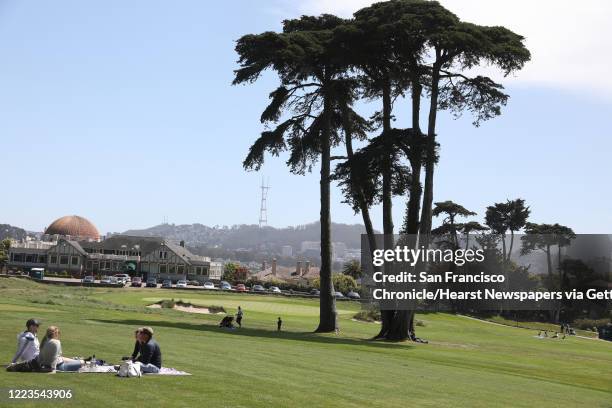 People soak up spring weather and relax in the fairway of the Presidio Golf Course, which reopened to golfers on Monday., May 4. This scene was...