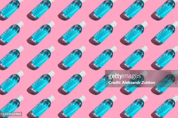 pattern of antibacterial and hand sanitizer on a pink background. - hand sanitiser stock pictures, royalty-free photos & images
