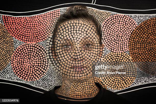 Australian Cricketer Ash Gardiner poses with one of her original paintings at her home on May 08, 2020 in Sydney, Australia. Gardiner tried...