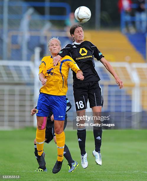 Leipzig's Ann-Katrin Schinkel jumps for a header with Kerstin Garefrekes of Frankfurt during the Women's Bundesliga match between 1. FC Lok Leipzig...