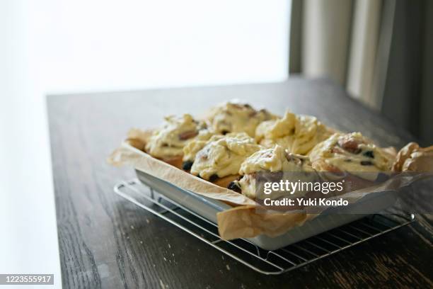 freshly baked cinnamon bun coated with cheese cream - cheese spread ストックフォトと画像