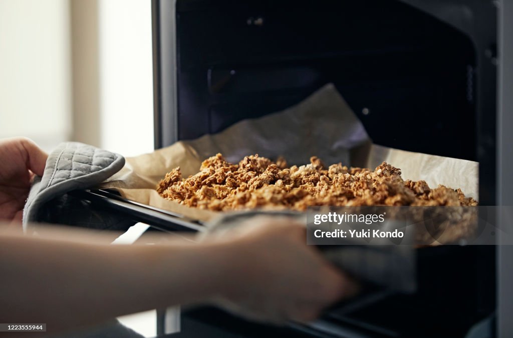 Take the homemade granola out of the oven.