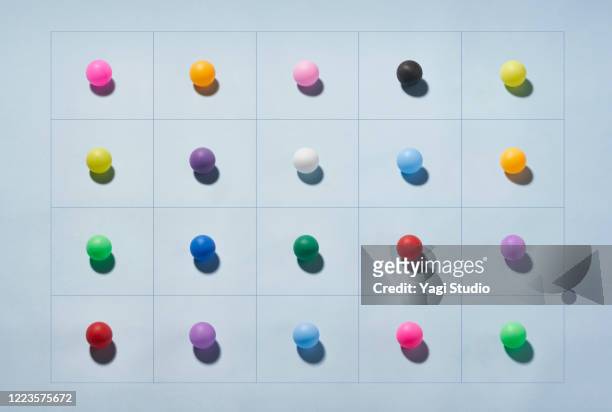 conceptual image of social distancing - multi coloured balls stock pictures, royalty-free photos & images