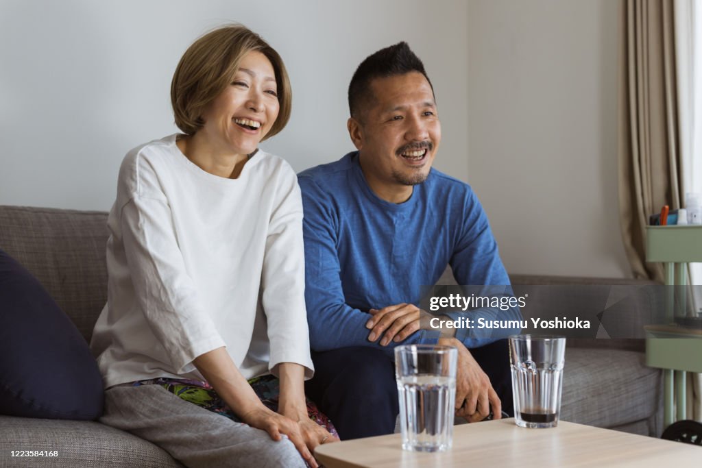 Couple watching tv on sofa