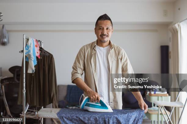 household husband ironing a shirt - 40代 男性 ストックフォトと画像