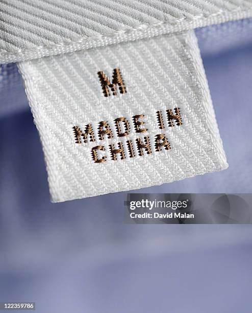cu of "made in china" label on clothing - made in china tag stock pictures, royalty-free photos & images