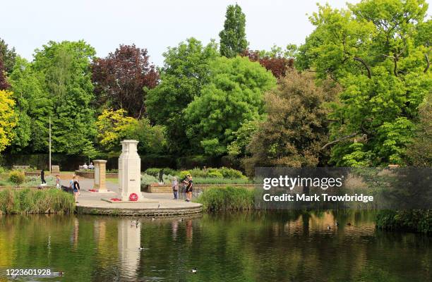 Members of the public take part in the VE day two minute silence at the Carshalton Ponds War Memorial on May 08, 2020 in Carshalton, United Kingdom....