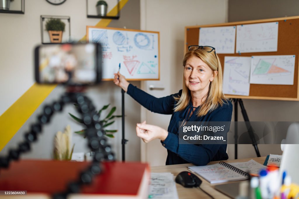 Cheerful professor communicate with pupils over video call