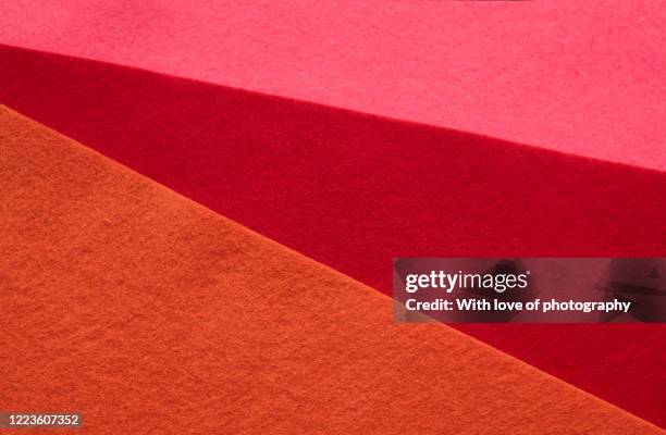 pink, red and orange felt sheets texture background - felt textile stock-fotos und bilder