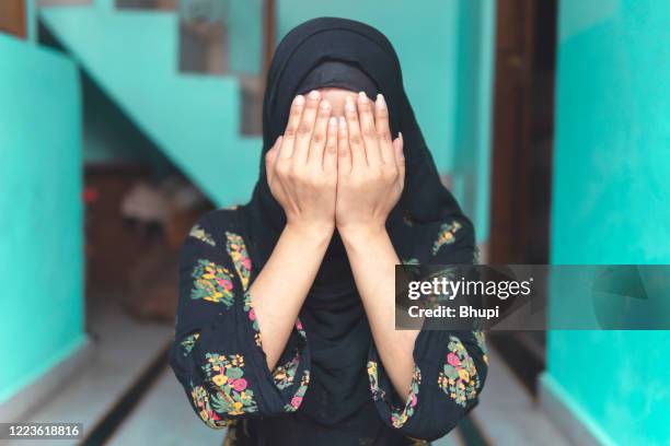 beautiful muslim woman is praying at home. ramadan namaz time. - namaz stock pictures, royalty-free photos & images