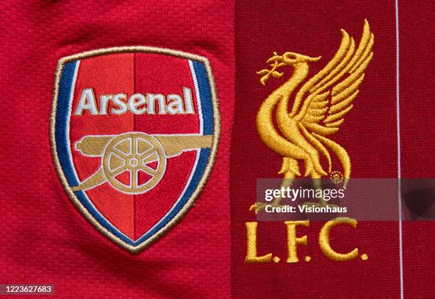 The Liverpool and Arsenal club crests on their first team home shirts on May 4, 2020 in Manchester, England