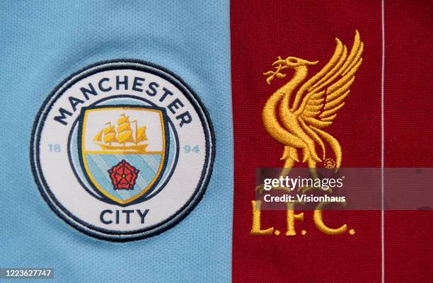 The Liverpool and Manchester City club crests on their first team home shirts on May 4, 2020 in Manchester, England