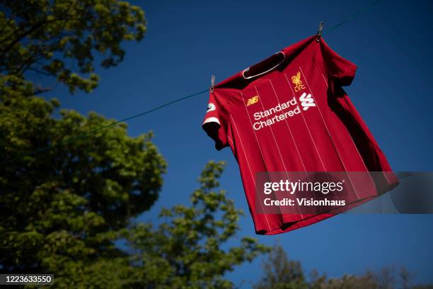 The Liverpool FC home shirt on a washing line displayed on May 6, 2020 in Manchester, England