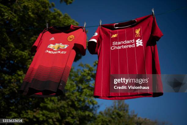 The Liverpool and Manchester United home shirts on a washing line on May 6, 2020 in Manchester, England