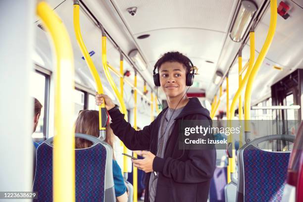 boy with mobile phone traveling in bus - autobus stock pictures, royalty-free photos & images