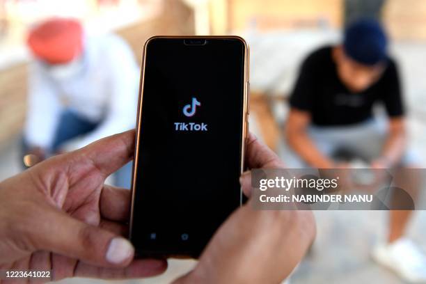 Indian mobile users browses through the Chinese owned video-sharing 'Tik Tok' app on a smartphones in Amritsar on June 30, 2020. TikTok on June 30...