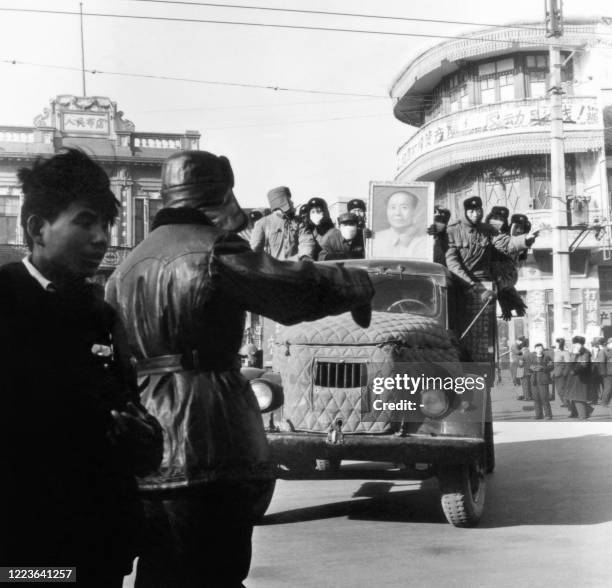 Chinese Red Guards are seen in a truck with a portrait of Mao Zedong in Beijing in the late 60s during the "great proletarian Cultural Revolution". -...