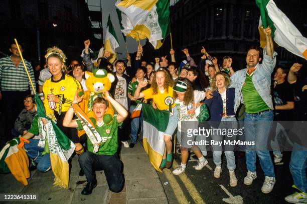Dublin , Ireland - 1 July 1990; Republic of Ireland supporters cheer on their team as they are brought by open top bus from Dublin Airport to College...