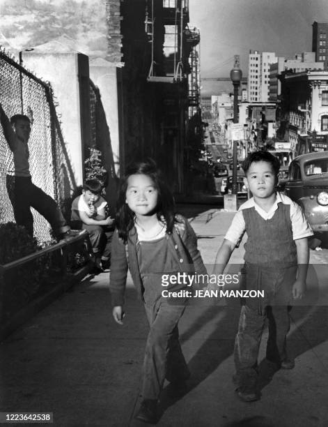 Chinese American children walk in a street of Chinatown, in January 1947, in San Francisco.