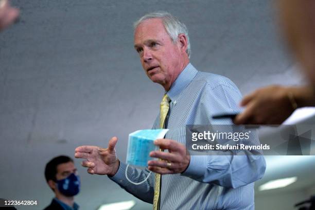 Sen. Ron Johnson speaks to members of the media as he arrives for the weekly Senate Republican policy luncheon in the Hart Senate Office Building on...