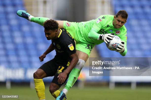 Reading's Rafael Cabral Barbosa claims the ball over Brentford's Ollie Watkins during the Sky Bet Championship match at the Madejski Stadium, Reading.
