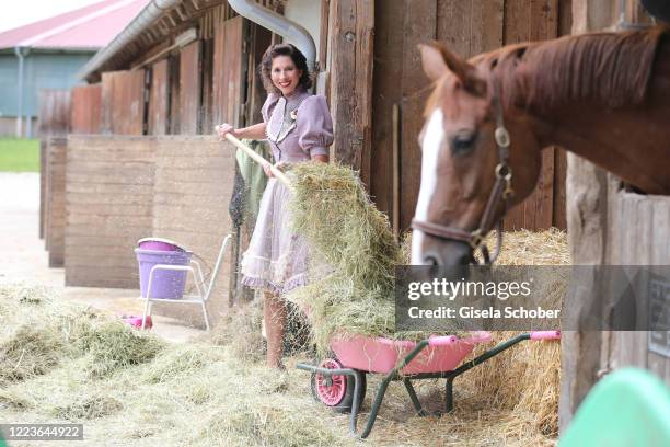 Dirndl fashion designer Lola Paltinger poses during a photo shooting to present her new Dirndl collection on June 25, 2020 at the Reit- und Zuchtfarm...