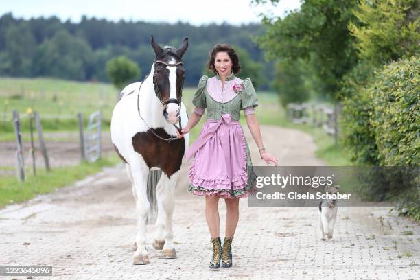 Dirndl fashion designer Lola Paltinger poses with her horse Casper during a photo shooting to present her new Dirndl collection on June 25, 2020 at...