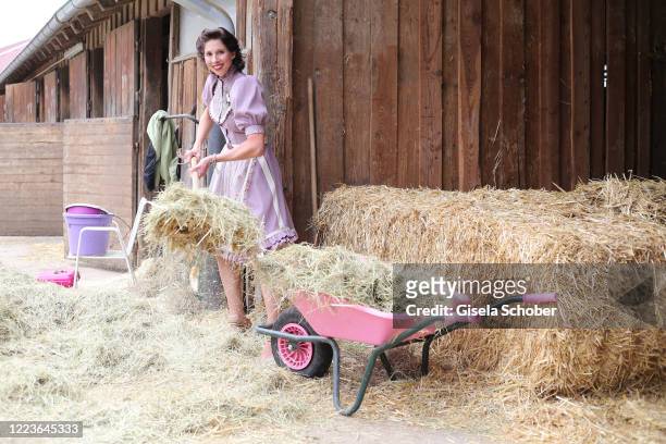 Dirndl fashion designer Lola Paltinger poses during a photo shooting to present her new Dirndl collection on June 25, 2020 at the Reit- und Zuchtfarm...