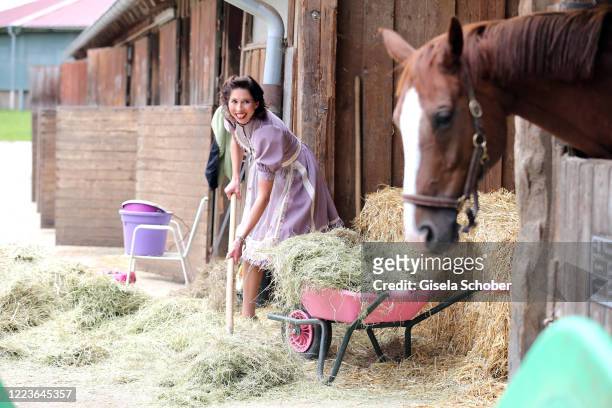 Dirndl fashion designer Lola Paltinger poses during a photo shooting to present her new Dirndl collection on June 25, 2020 at the Reit- und Zuchtfarm...